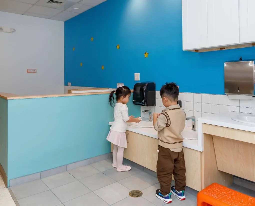 Two children at a height-appropriate sink at a facility that received a Children's Investment Fund grant.
