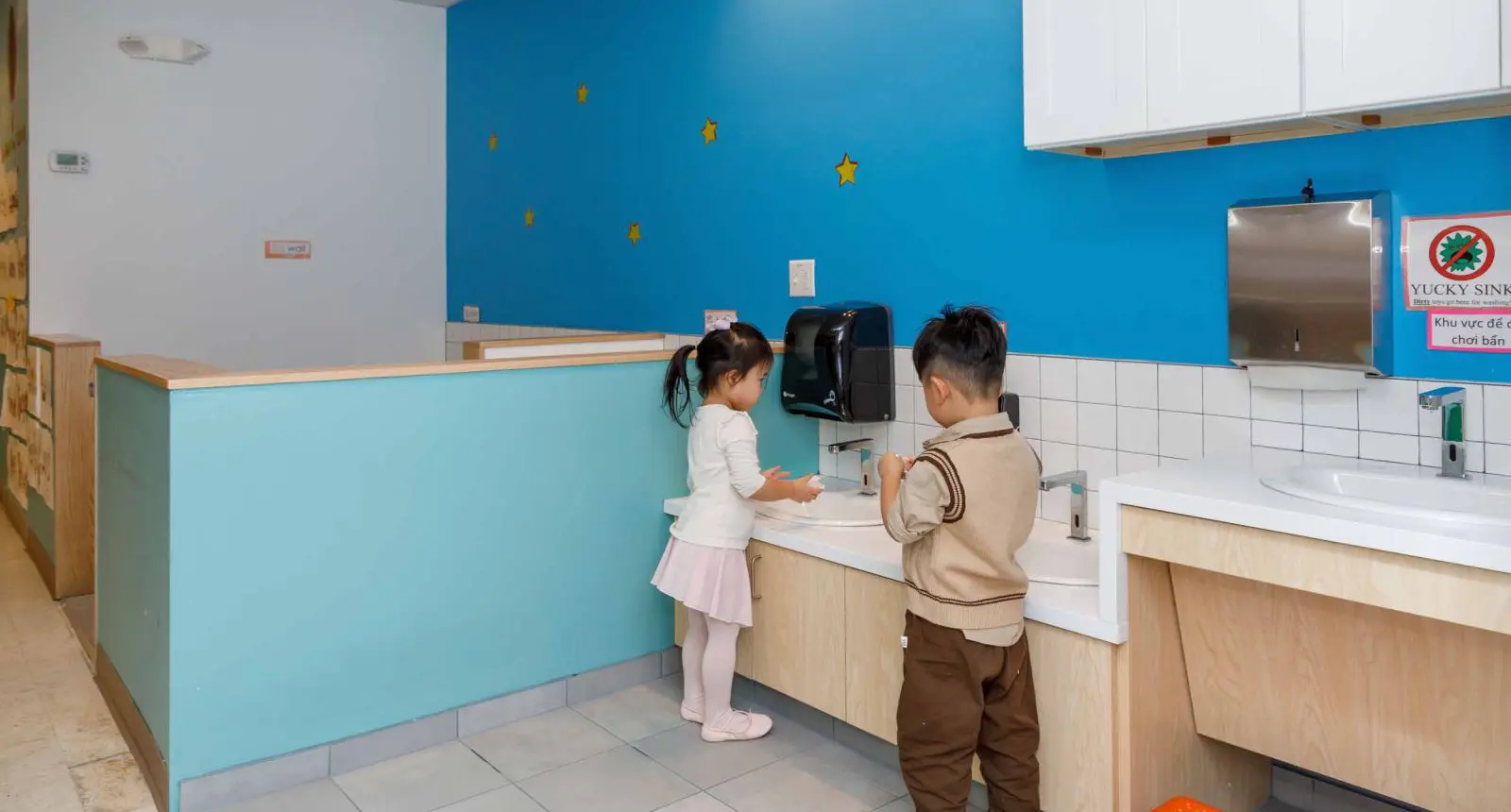 Two children at a height-appropriate sink at a facility that received a Children's Investment Fund grant.
