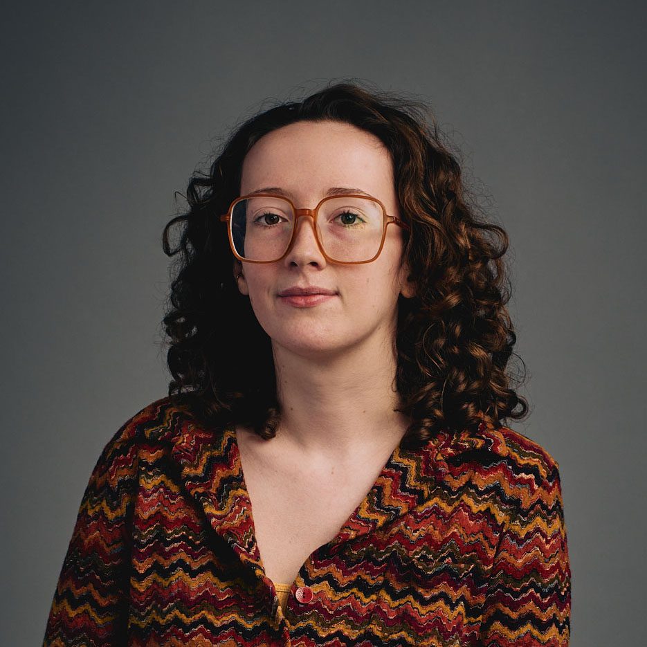 Auburn haired woman wearing glasses